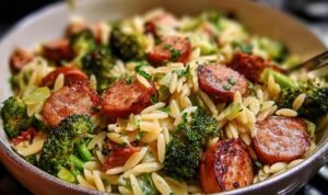Chicken sausage broccoli orzo in a large pot with Parmesan cheese and fresh parsley