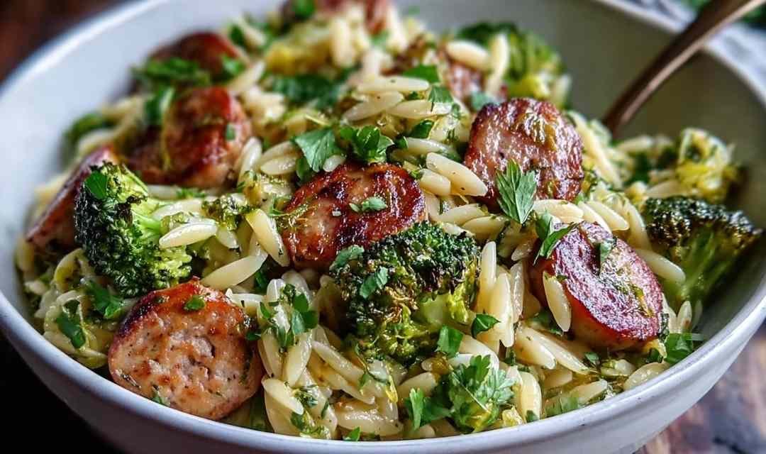 Chicken sausage broccoli orzo in a large pot with Parmesan cheese and fresh parsley