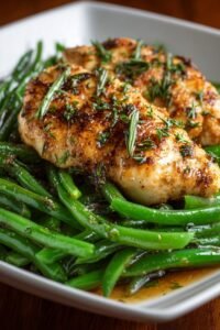 Chicken breast and green beans in honey soy sauce in a skillet with glossy glaze