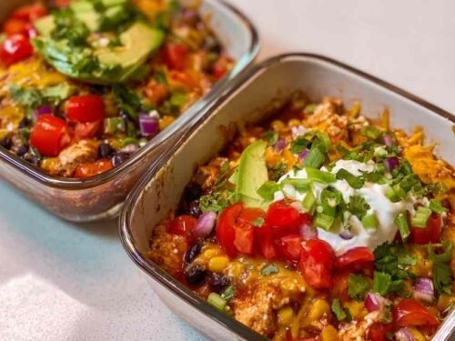 High-Protein Chicken Cottage Cheese Enchilada Bowls topped with avocado cilantro and cheese