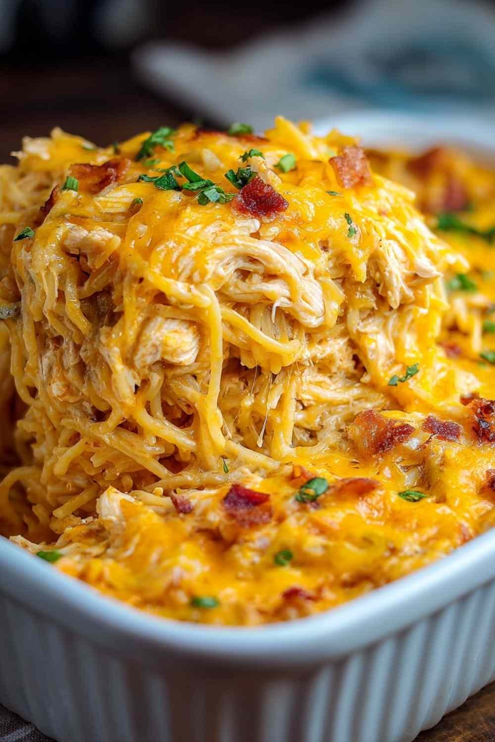 Spicy Southern Cheesy Chicken Spaghetti Casserole with melted cheese and green onions served on white plate