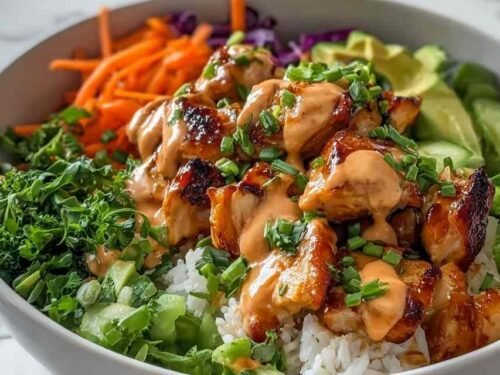 Bang Bang Chicken Bowl with golden sauteed chicken, colorful mixed vegetables, and creamy Bang Bang sauce served over white rice in a bowl