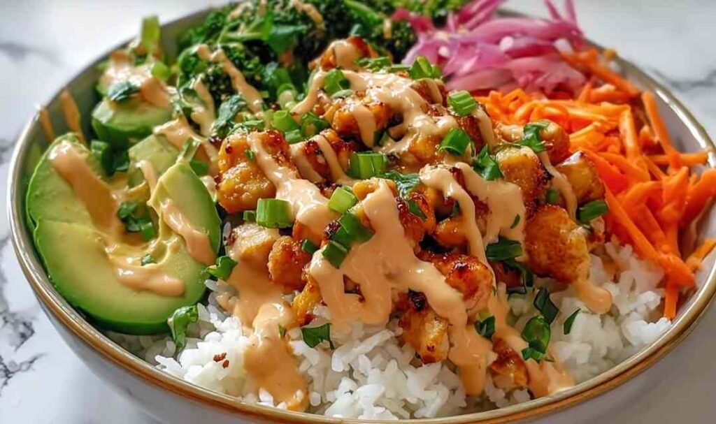 Bang Bang Chicken Bowl with golden sauteed chicken, colorful mixed vegetables, and creamy Bang Bang sauce served over white rice in a bowl