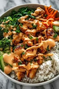 Bang Bang Chicken Bowl with golden sauteed chicken, colorful mixed vegetables, and creamy Bang Bang sauce served over white rice in a bowl