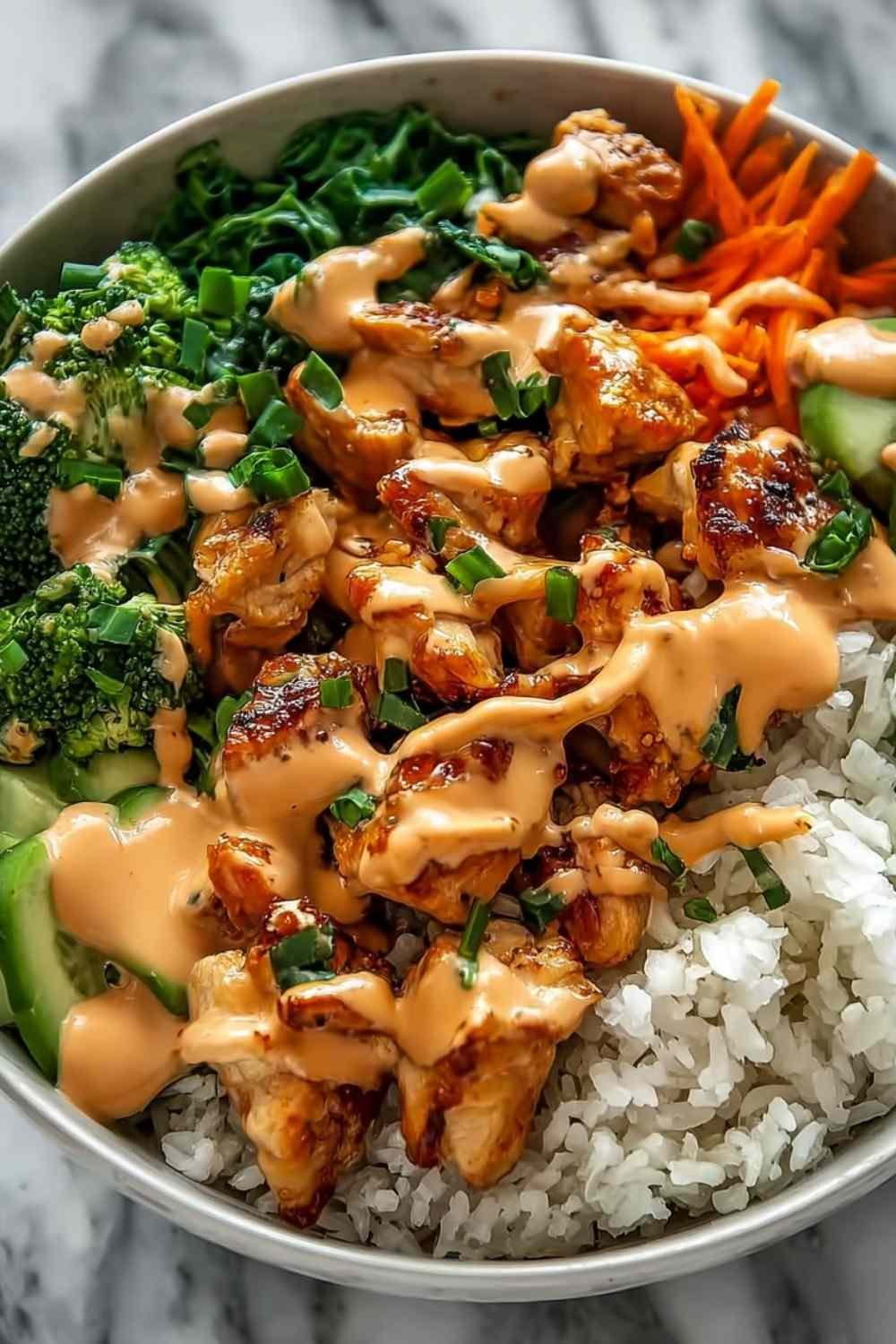 Bang Bang Chicken Bowl with golden sauteed chicken, colorful mixed vegetables, and creamy Bang Bang sauce served over white rice in a bowl