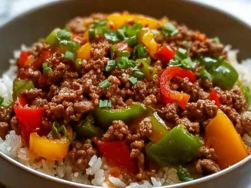 Beef pepper rice bowl in a large skillet with seasoned ground beef, colorful bell peppers, and jasmine rice