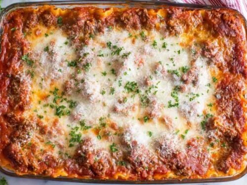 Classic lasagna recipe baked in a 9x13 dish with golden melted mozzarella and bubbling meat sauce