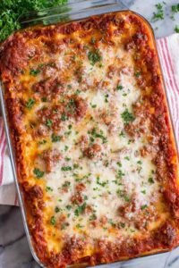 Classic lasagna recipe baked in a 9x13 dish with golden melted mozzarella and bubbling meat sauce