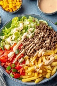 Big Mac bowls with seasoned ground beef shredded iceberg lettuce cheddar and special sauce drizzle