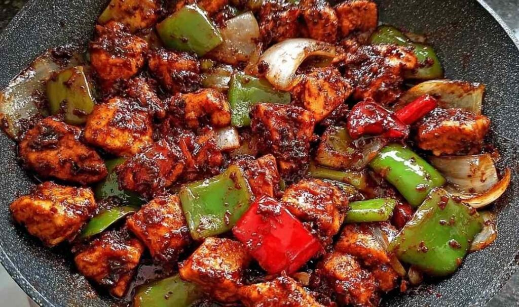 Easy black pepper chicken recipe served over steamed jasmine rice in a white bowl