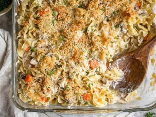 Easy homemade tuna casserole in a 9x13 baking dish with golden panko Parmesan topping and fresh parsley