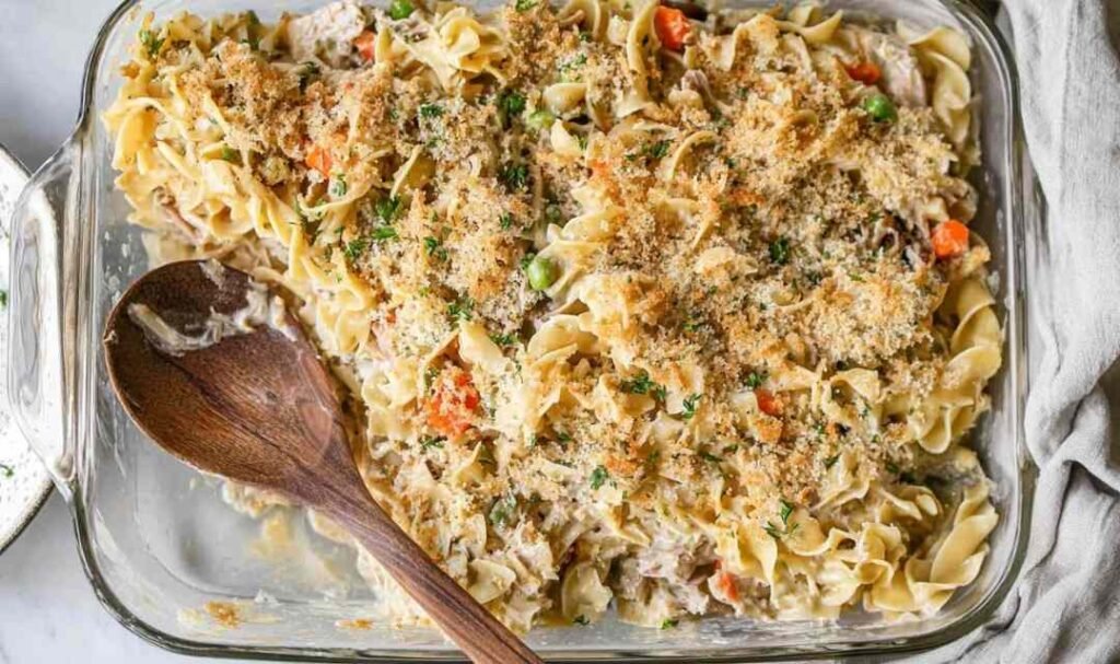 Easy homemade tuna casserole in a 9x13 baking dish with golden panko Parmesan topping and fresh parsley