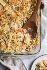 Easy homemade tuna casserole in a 9x13 baking dish with golden panko Parmesan topping and fresh parsley
