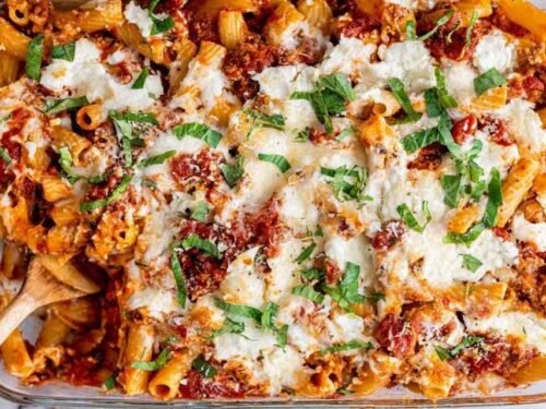 Baked Ziti in a 13x9 baking dish fresh from the oven with golden brown melted mozzarella and Parmesan on top