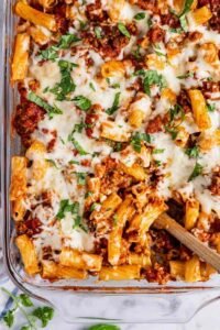 Baked Ziti in a 13x9 baking dish fresh from the oven with golden brown melted mozzarella and Parmesan on top