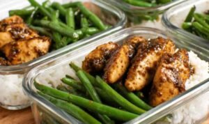 One pan chicken breast and green beans coated in honey soy sauce served over white rice