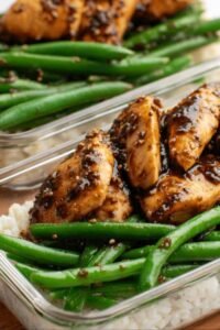 One pan chicken breast and green beans coated in honey soy sauce served over white rice