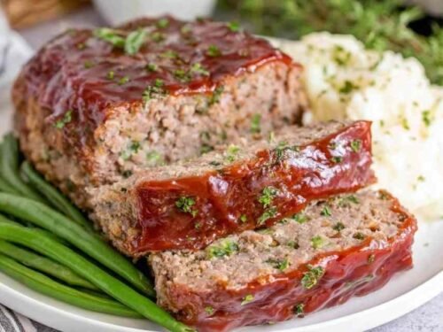 Homemade meatloaf recipe with caramelized ketchup glaze fresh out of the oven in a 9x5 loaf pan