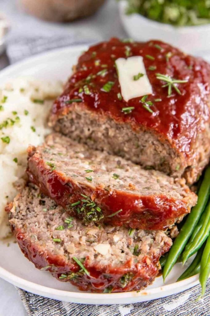 Homemade meatloaf recipe with caramelized ketchup glaze fresh out of the oven in a 9x5 loaf pan