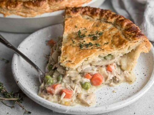 Unbaked turkey pot pie with crimped homemade butter crust in a deep dish pie pan ready for the oven at 425 degrees