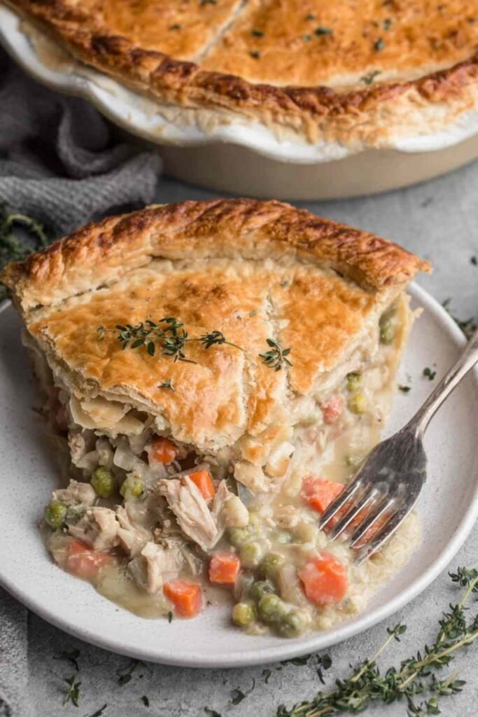Unbaked turkey pot pie with crimped homemade butter crust in a deep dish pie pan ready for the oven at 425 degrees