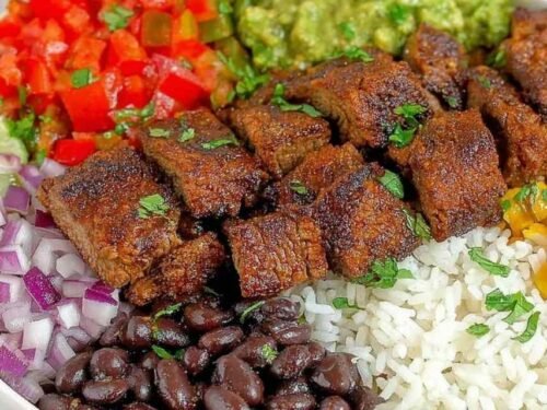 Copycat Chipotle steak cubes caramelizing in a cast iron skillet with smoky chipotle adobo marinade