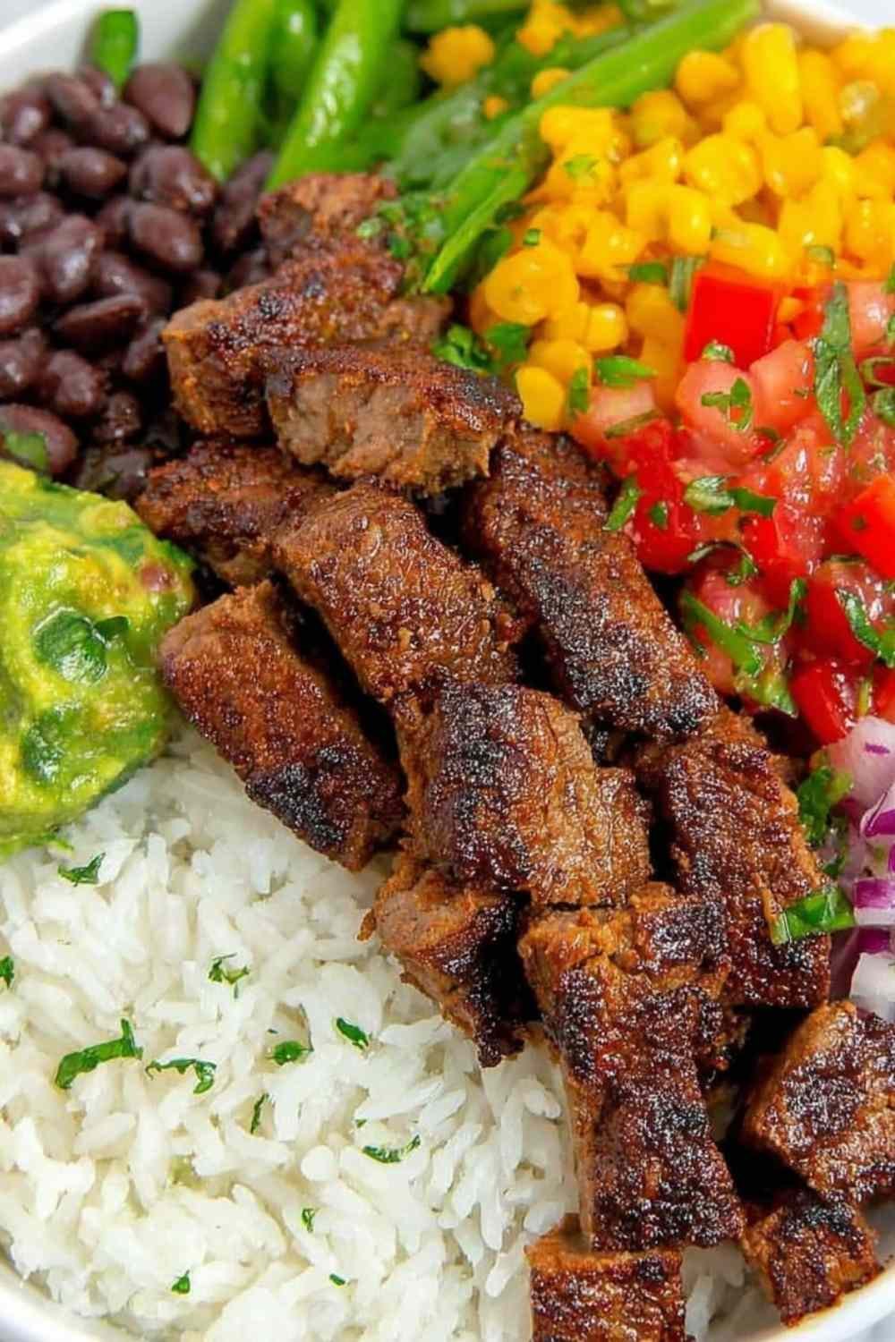 Copycat Chipotle steak cubes caramelizing in a cast iron skillet with smoky chipotle adobo marinade