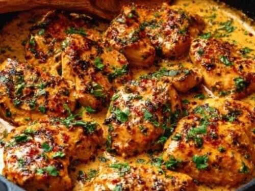 Cowboy Butter Chicken in a cast iron skillet with rich garlic butter sauce and fresh parsley garnish