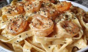 Creamy shrimp fettuccine Alfredo in a large skillet garnished with fresh parsley and Parmesan