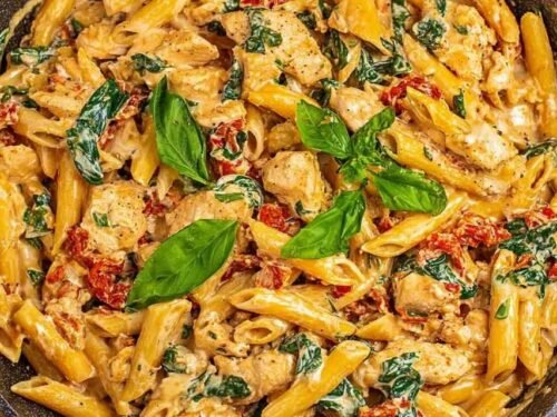 One pot tuscan chicken pasta with sun-dried tomatoes, spinach, and creamy Parmesan sauce in a large deep skillet