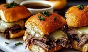 Crock Pot French Dip Sandwiches Crock Pot French Dip Sandwich with shredded beef and melted provolone cheese on a toasted hoagie roll served with a bowl of au jus for dipping