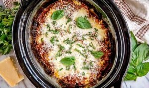 Easy crockpot lasagna with cheesy layers and marinara sauce cooking in a slow cooker