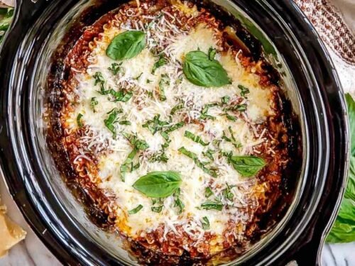 Easy crockpot lasagna with cheesy layers and marinara sauce cooking in a slow cooker