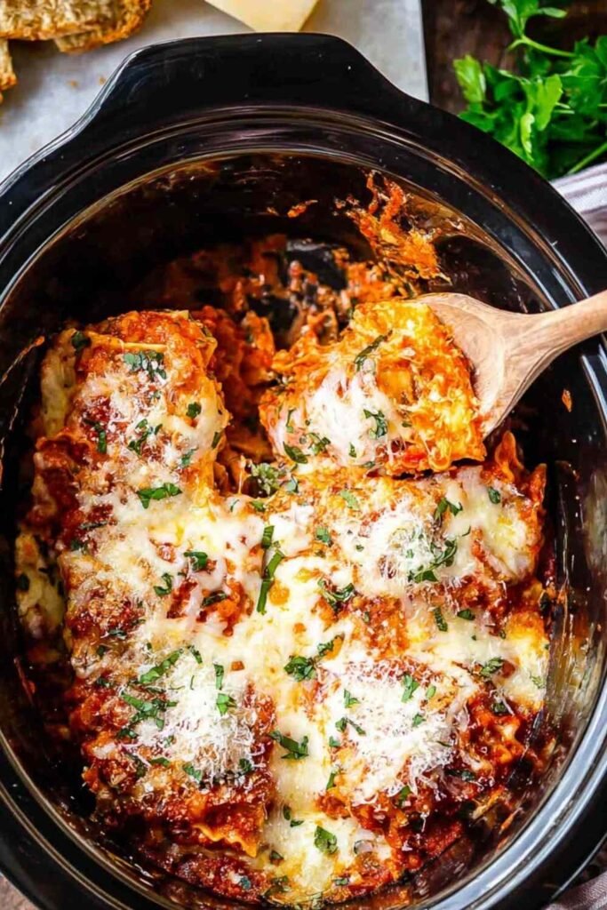 Easy crockpot lasagna with cheesy layers and marinara sauce cooking in a slow cooker