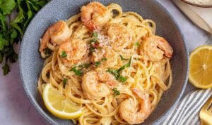 Easy Shrimp Pasta Easy shrimp pasta in a large skillet with garlic butter sauce, lemon zest, Parmesan, and fresh parsley
