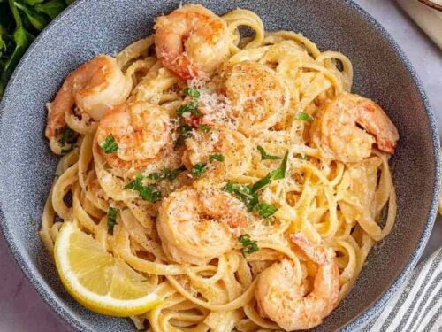 Easy shrimp pasta in a large skillet with garlic butter sauce, lemon zest, Parmesan, and fresh parsley