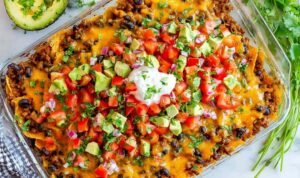 Easy taco casserole baked with melty cheese and served with sour cream, cilantro, and avocado