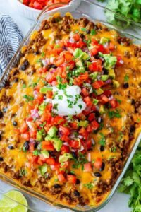 Easy taco casserole baked with melty cheese and served with sour cream, cilantro, and avocado