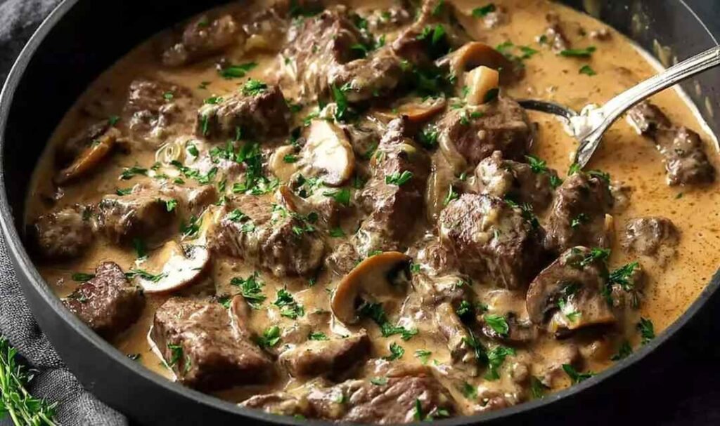 Gordon Ramsay's Beef Stroganoff served over buttered egg noodles, garnished with fresh chives
