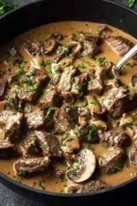 Gordon Ramsay's Beef Stroganoff served over buttered egg noodles, garnished with fresh chives
