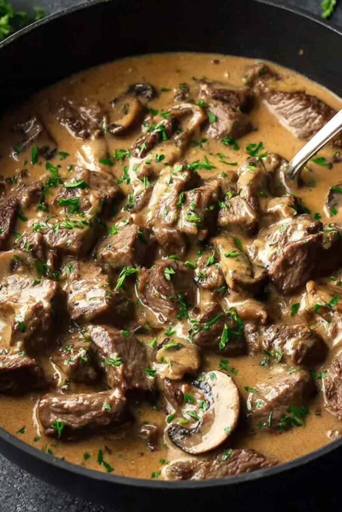 Gordon Ramsay's Beef Stroganoff served over buttered egg noodles, garnished with fresh chives