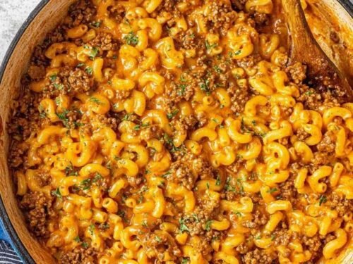 Homemade hamburger helper in a large pot with cheesy tomato sauce and seasoned ground beef