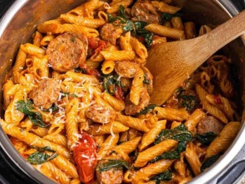 Instant Pot Pasta with Sausage with spinach and mozzarella stirred together in the pressure cooker pot