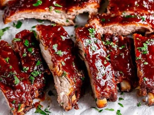 Fall-off-the-bone Instant Pot Ribs glazed with caramelized BBQ sauce on parchment paper