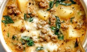 Italian Sausage and Potato Soup Bowl of Italian sausage and potato soup with creamy broth, wilted greens, and freshly grated Parmesan