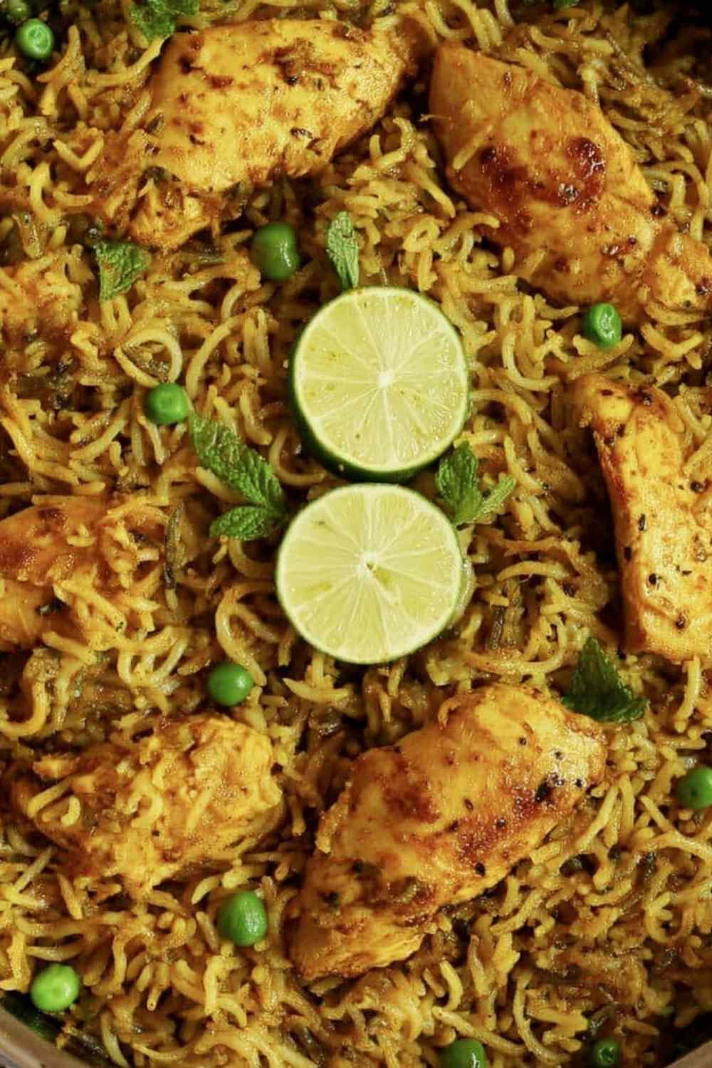 One pan Mediterranean chicken and rice with golden seared chicken, turmeric-spiced rice, and fresh herbs in a dark skillet