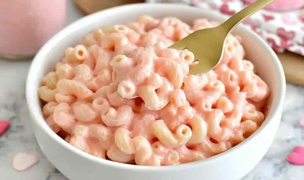 Creamy pink mac and cheese in a white bowl made with natural beet juice dairy-free