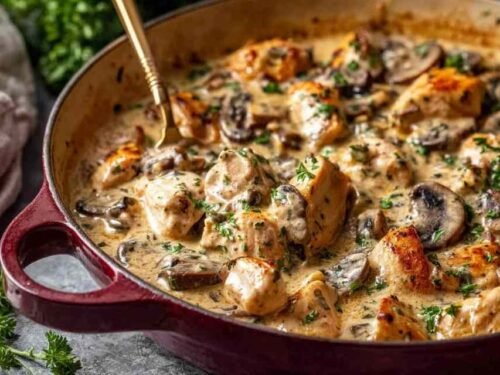 Rich chicken stroganoff in a skillet with creamy mushroom sauce and golden seared chicken pieces