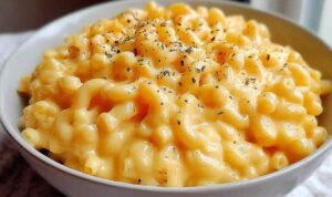 Simple Mac And Cheese Bowl of simple mac and cheese with creamy cheddar sauce coating elbow macaroni