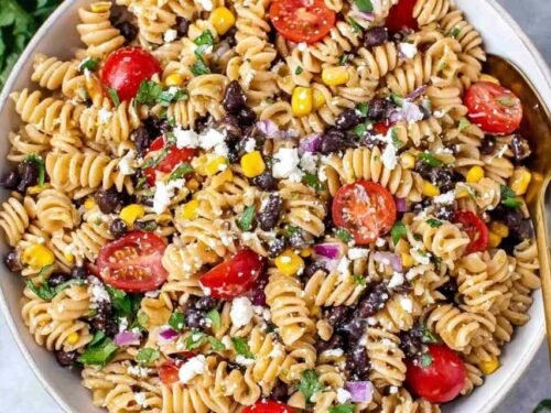 Colorful Southwest Pasta Salad with black beans, corn, tomatoes, and Cotija cheese in a large white bowl